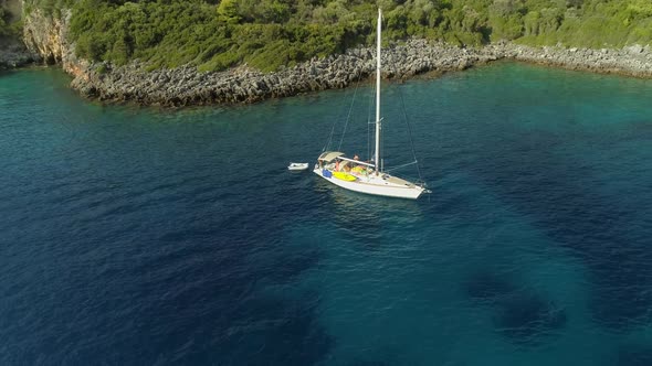 Aerial view of sailboat anchored in the mediterranean sea, Nisi, Greece.