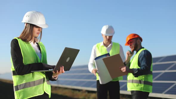 A Female Engineer is Entering Data Into a Laptop