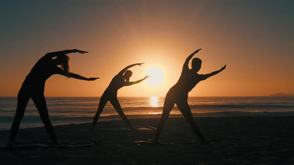 Group Of Women Practicing Yoga