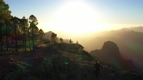 Man Running Sun As Sets Over Misty Mountain