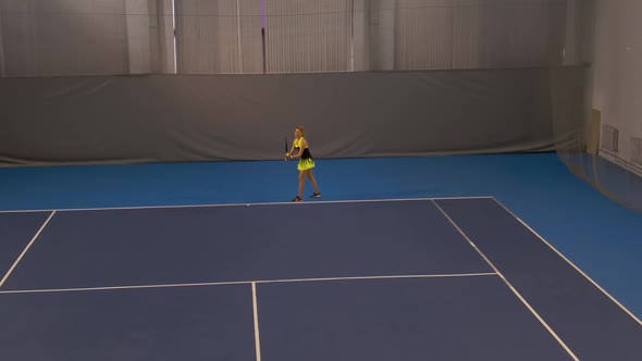 Wide Shot of Beautiful Young Sportswoman Serving Ball in Big Tennis Game. Confident Concentrated