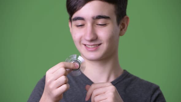 Young Handsome Iranian Teenage Boy Against Green Background