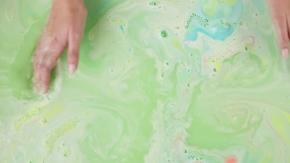 Hands Touching Green Water Closeup Dissolved Bath Bomb