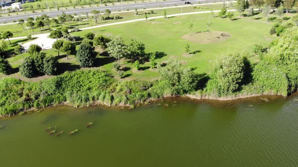 . AERIAL VIEW. The Lake in the Park in City. Sunny Day, Beautiful Scenery with a Lake in the Park.