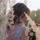 A Young Woman Dressed in a Gray Wedding Dress. She Has Flowers in Her Hand and Is in the Park - VideoHive Item for Sale