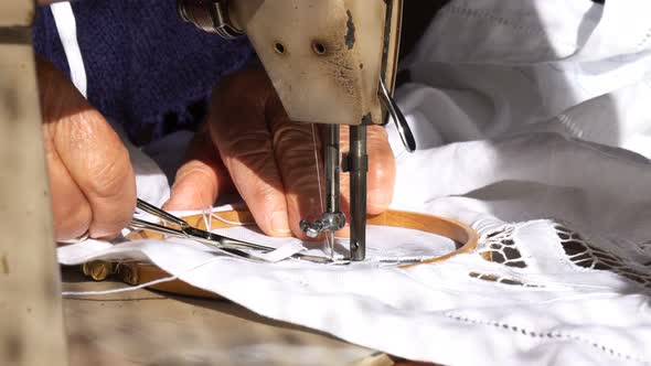 Old Woman is Working with a Sewing Machine