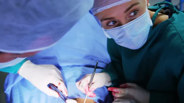 Surgeons performing operation in operation room