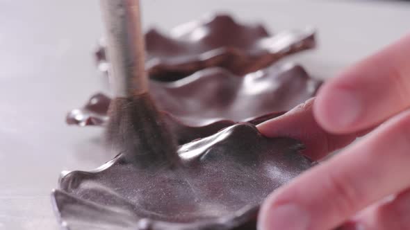 Pastry Chef Covers the Chocolate with Gray Kandurin to Decorate the Cake