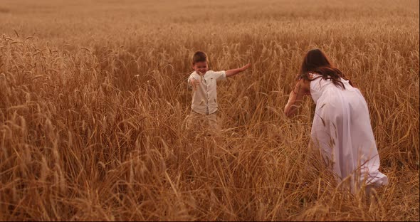 Happy Father Twisting Child on Meadow.