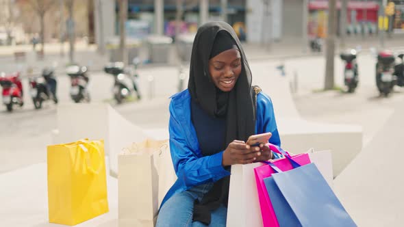 Muslim Shopper Texting on Smartphone