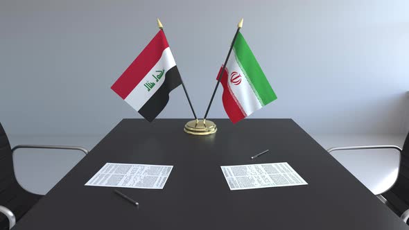 Flags of Iraq and Iran and Papers on the Table
