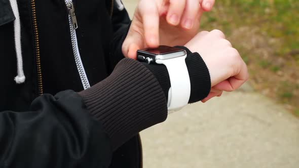 Woman using smartwatch in the park 4k