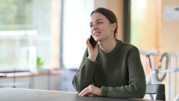 Happy Young Woman Talking on Phone