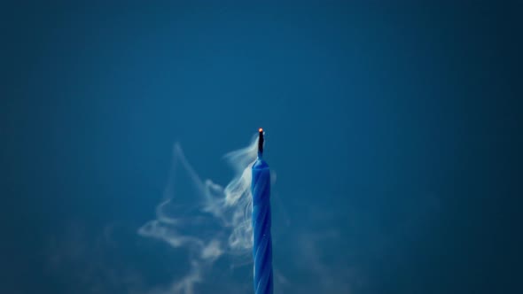 Deep Blue Candle on Deep Blue Background Was Blown and Smoke Disappearing