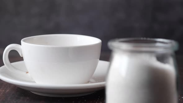 White Sugar and Spoon in a Container on Black Background