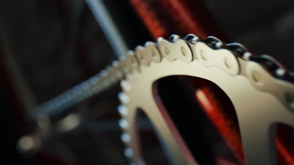 Bicycle over a black background. Loopable shot of spinning chain and chainring.