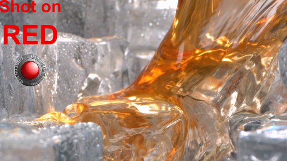 Drinking Whiskey Is Pouring With Ice Inside A Glass In High Speed