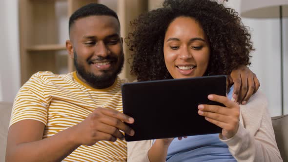 African American Couple with Tablet Pc at Home