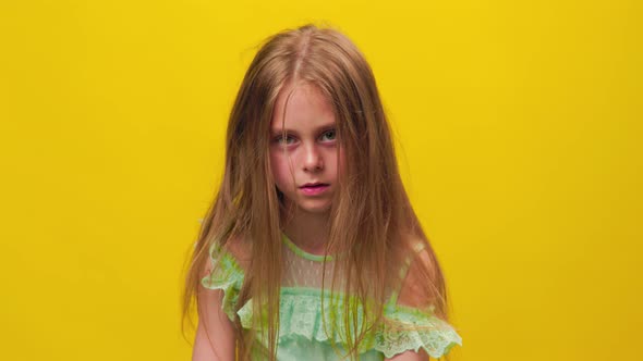 Unhappy Kid Girl Disheveled Tousled and Dirty Hair and Looking at Camera