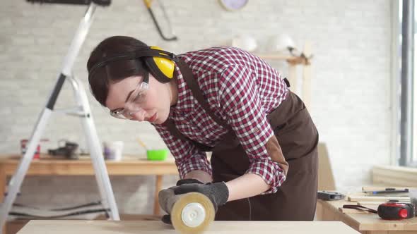 Close Up Professional Carpenter Woman in Charge of Polishing the Wooden Tableslow Mo