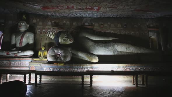 DAMBULLA, SRI LANKA - FEBRUARY 2014: Big reclining Buddha at the Golden Temple of Dambulla. The Gold