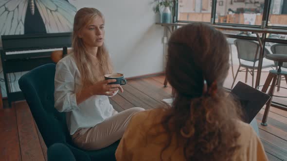 Two Girls Meet in a Coffee Shop