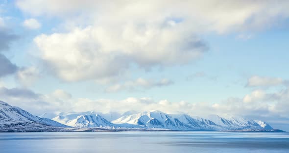 Cloud rolling time lapse over snow mountain fjords in Akureyri, Iceland.