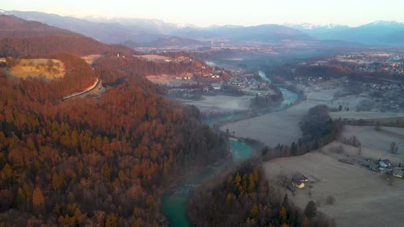 Flying over the river and hills at sunrise