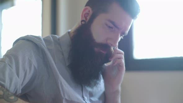 Bearded man talking on cell phone