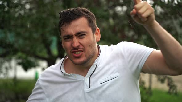 Angry Man Shouting Threatening with a Finger and Shouting Aggressively at the Camera