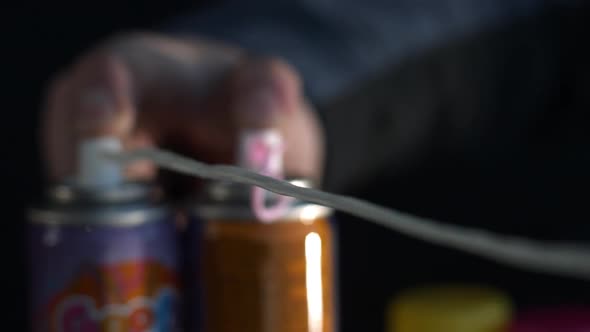 Two cans of silly string shooting in slow motion alt