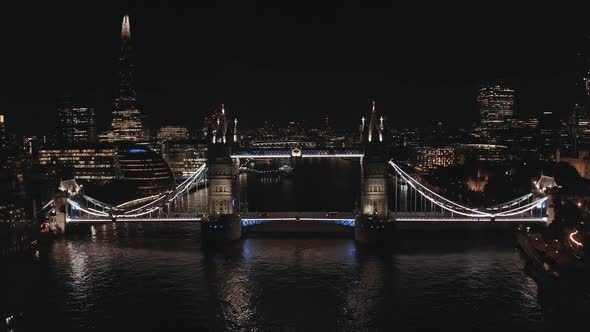 Aerial View to the Illuminated Tower Bridge and Skyline of London at Night UK