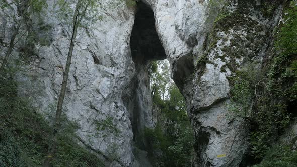 Arch and  nature of  Eastern Serbia 4K 2160p 30fps UltraHD footage - Hiker under   natural stone bri