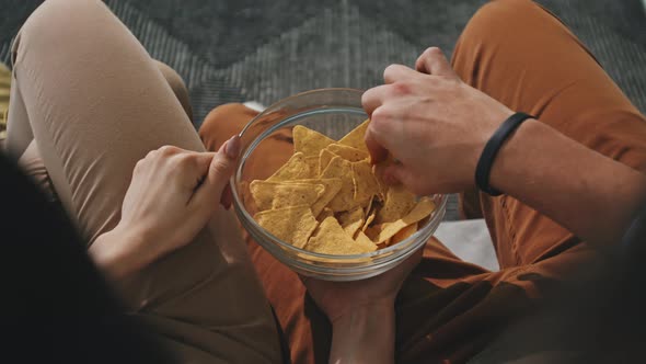 Couple With Bowl Of Nachos