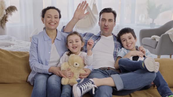 Joyful Family with Kids During Video Chat at Home