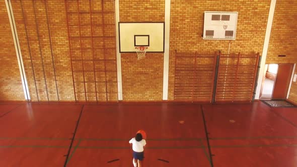 Boys playing basketball in court