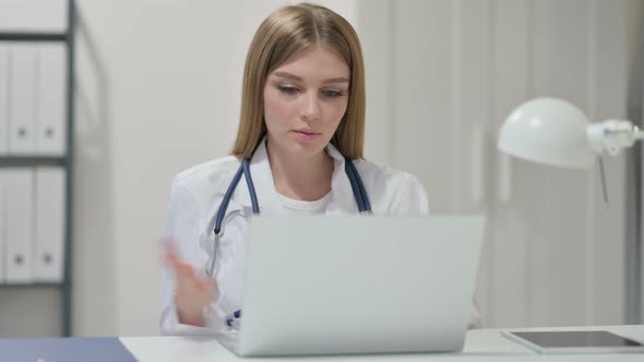 Video Chat on Laptop By Young Female Doctor 