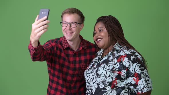 Overweight African Woman and Young Scandinavian Man Together Against Green Background