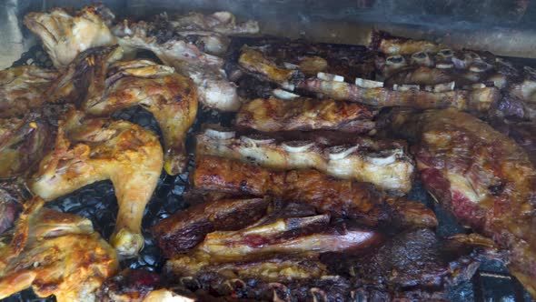 Ribs, beef, chicken and chorizos being roasted in traditional Argentinian asado