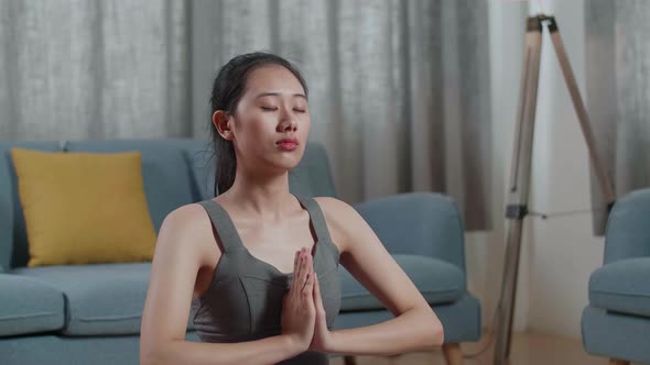 Asian Athletic Female Doing Yoga In Sukhasana Pose During Workout On Yoga Mat At Home