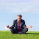 Businessman practicing yoga in the lotus position in a park - VideoHive Item for Sale