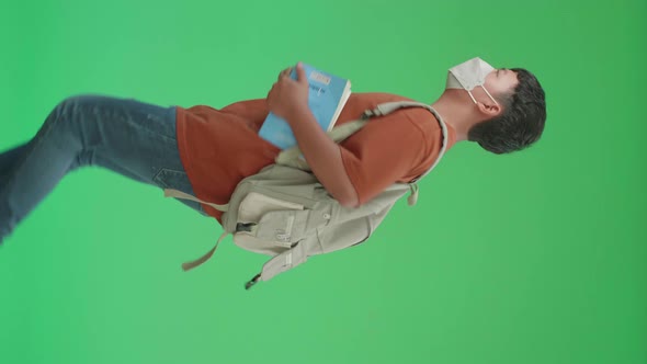 Asian Boy Student Wearing A Mask, Holding A Book And Running To School On Green Screen