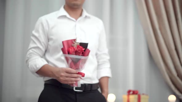 Man hold the bouquet flower to surprise his girl in valentines celebration day.