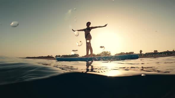 Stretching Exercises on a Paddle Sup Board