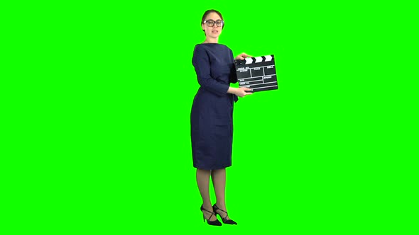 Director Is Holding a Movie in the Hands and Announcing the Scene. Green Screen