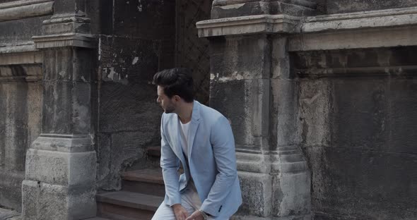 Young Man Waiting For A Meeting Near The House