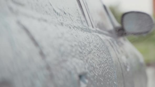 Cleaning Foam is Applied to the Car at the Car Wash