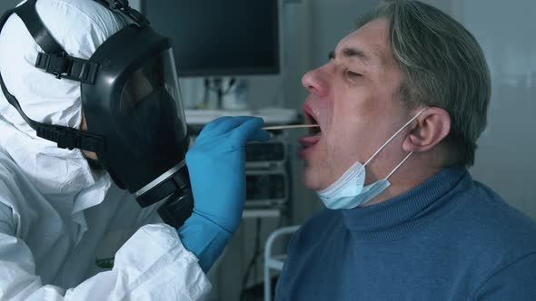 Throat Examination of a Male Patient Held By a Doctor. Infection, Covid-19 Pandemic, 2019-Ncov