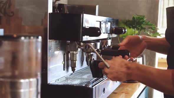 Waiter making cup of coffee