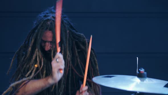 Talented Musician with Dreadlocks Play on Drums in Smoke in a Club